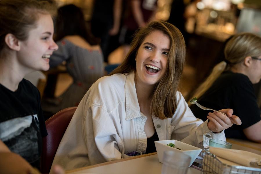 Students enjoying a meal in the Commons dining hall.