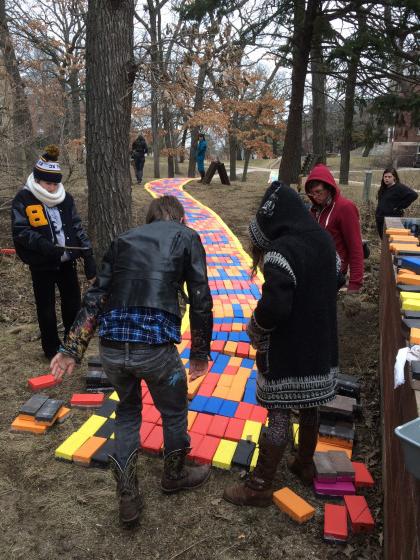 Students install Beloit Path by Lisa Anne Auerbach, who proposed the project as Ferrall Visiting Artist in Residence in 2014.